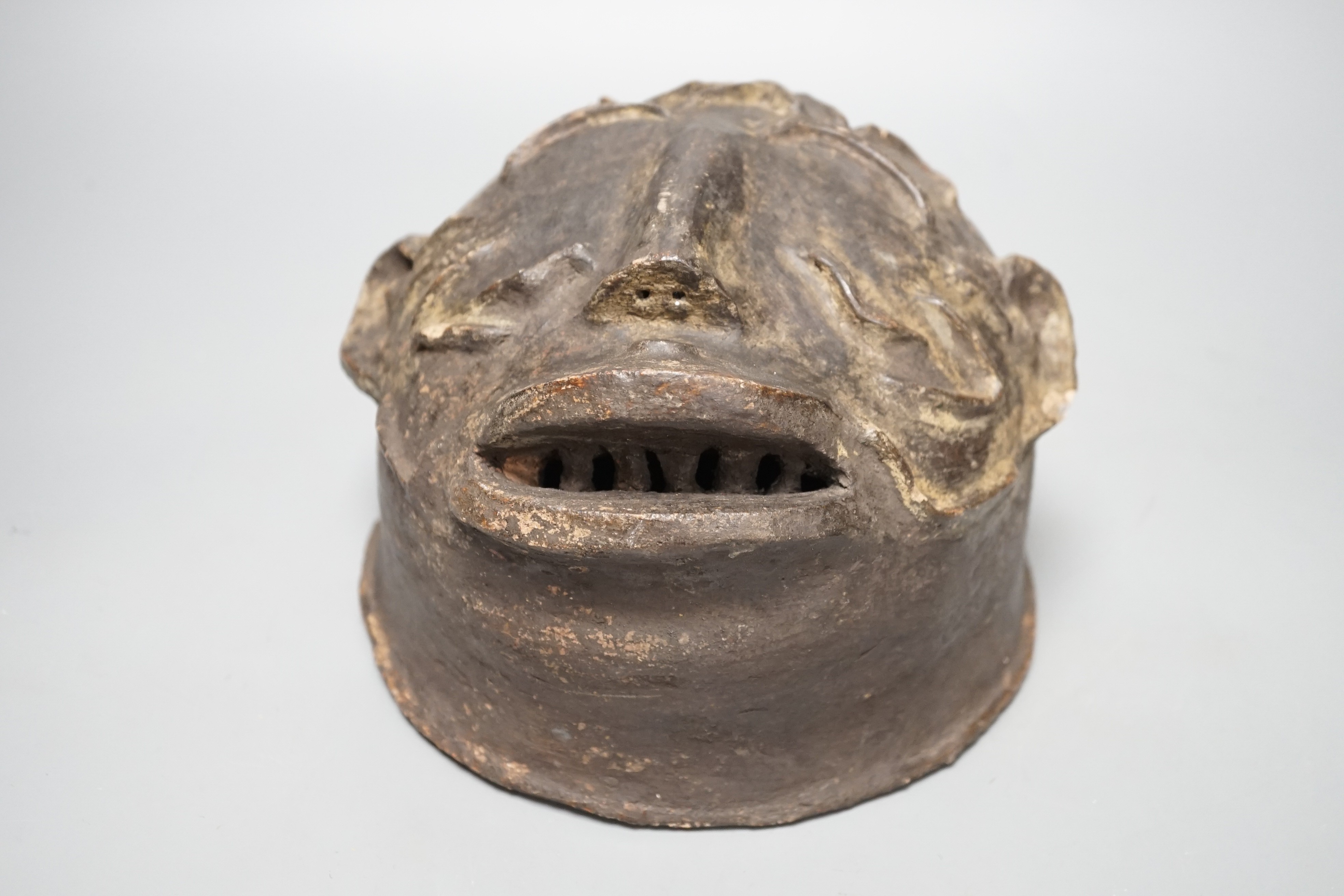 A terracotta Makonde helmet mask (Tanzanian) 21cm diameter